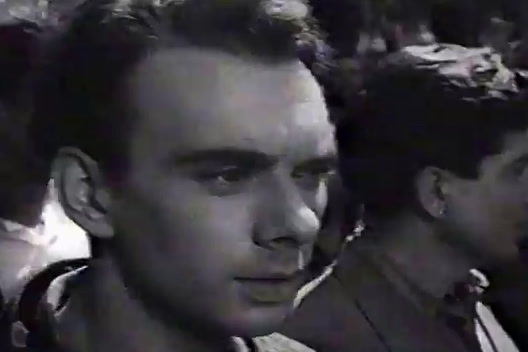 a black and white photo of a man in a crowd