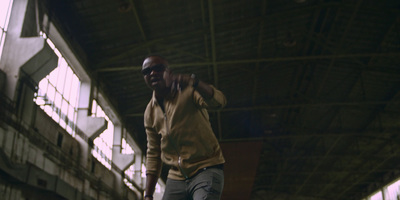 a man in a yellow shirt is standing in a warehouse