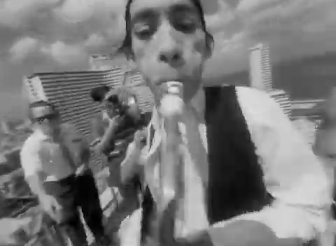 a black and white photo of a man brushing his teeth