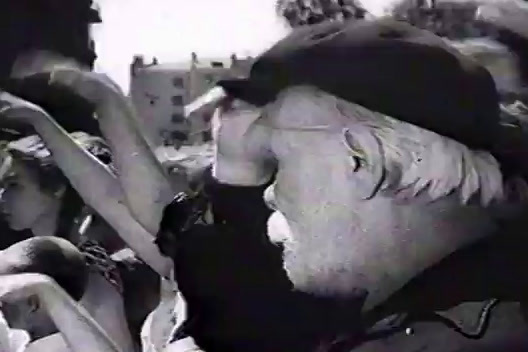 a black and white photo of a man talking on a cell phone