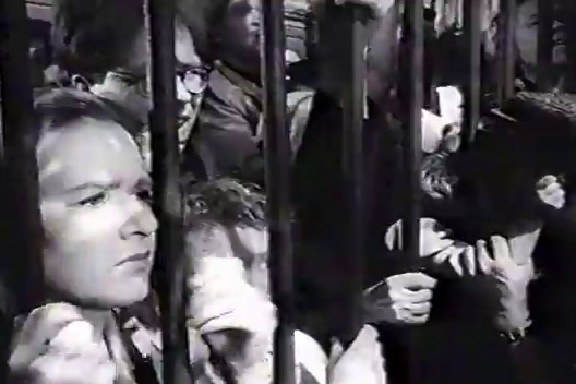 a black and white photo of people on a bus