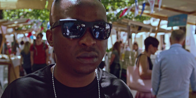 a man in sunglasses standing in front of a crowd