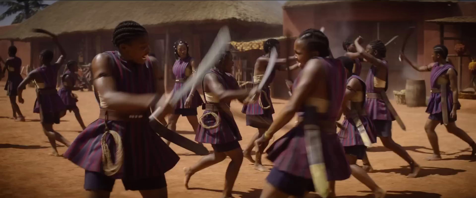 a group of people in purple outfits holding swords