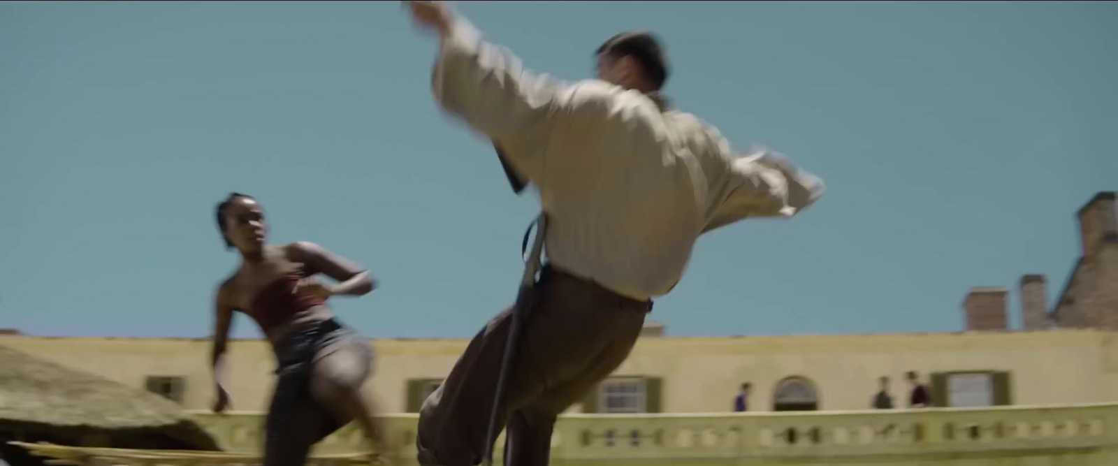 a man in a white shirt is doing a trick on a skateboard