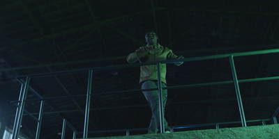 a man standing on a railing in a building