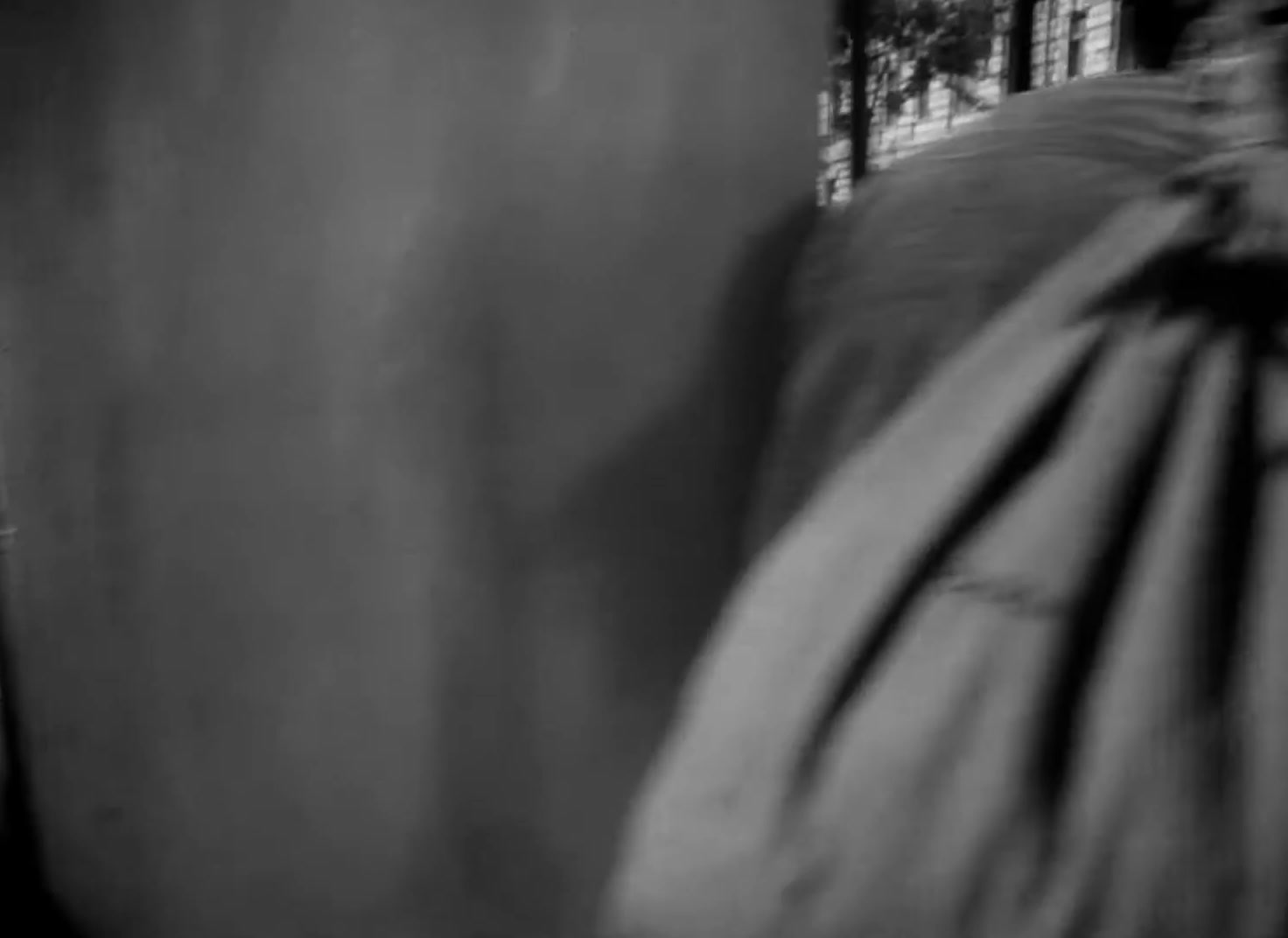 a black and white photo of a person holding an umbrella