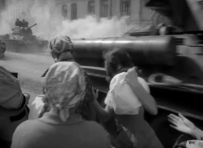 a group of people standing around a tank