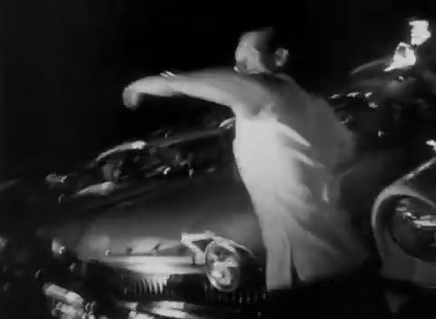 a black and white photo of a man on a motorcycle