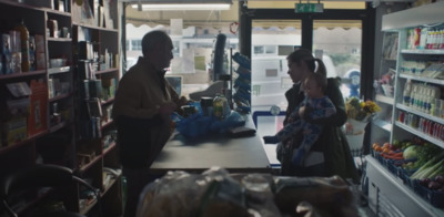 a man and a woman standing in a grocery store