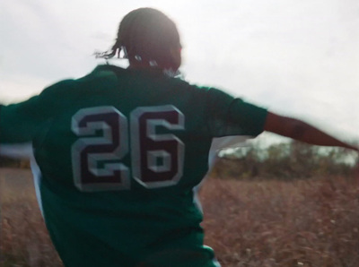 a person in a field with a frisbee