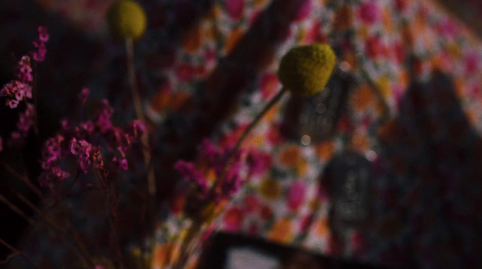 a close up of a vase with flowers in it