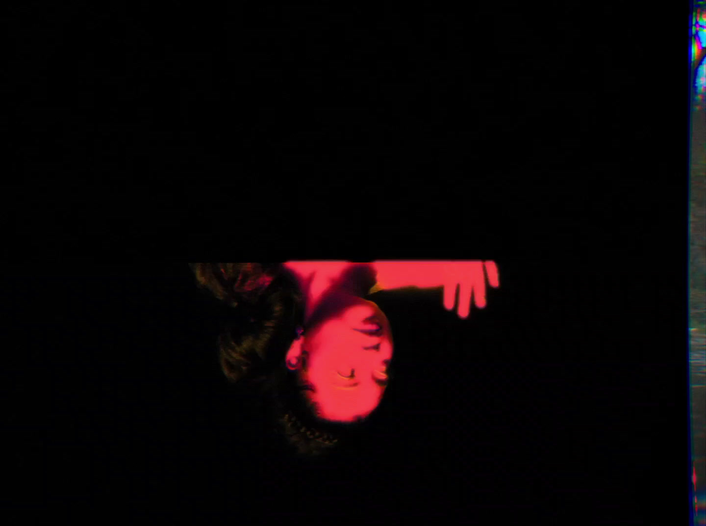 a woman laying on her back in the dark