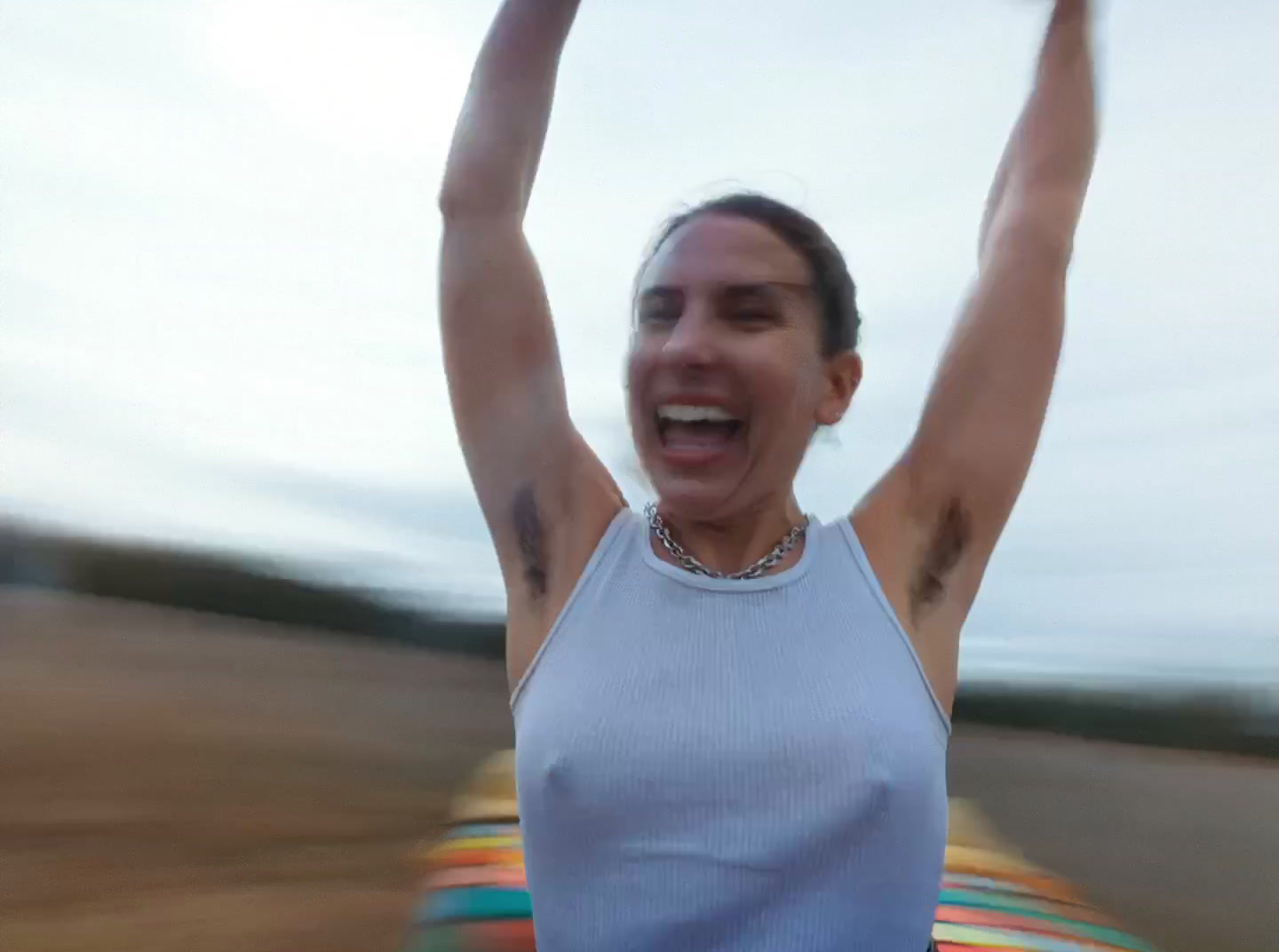 a woman holding a frisbee up in the air