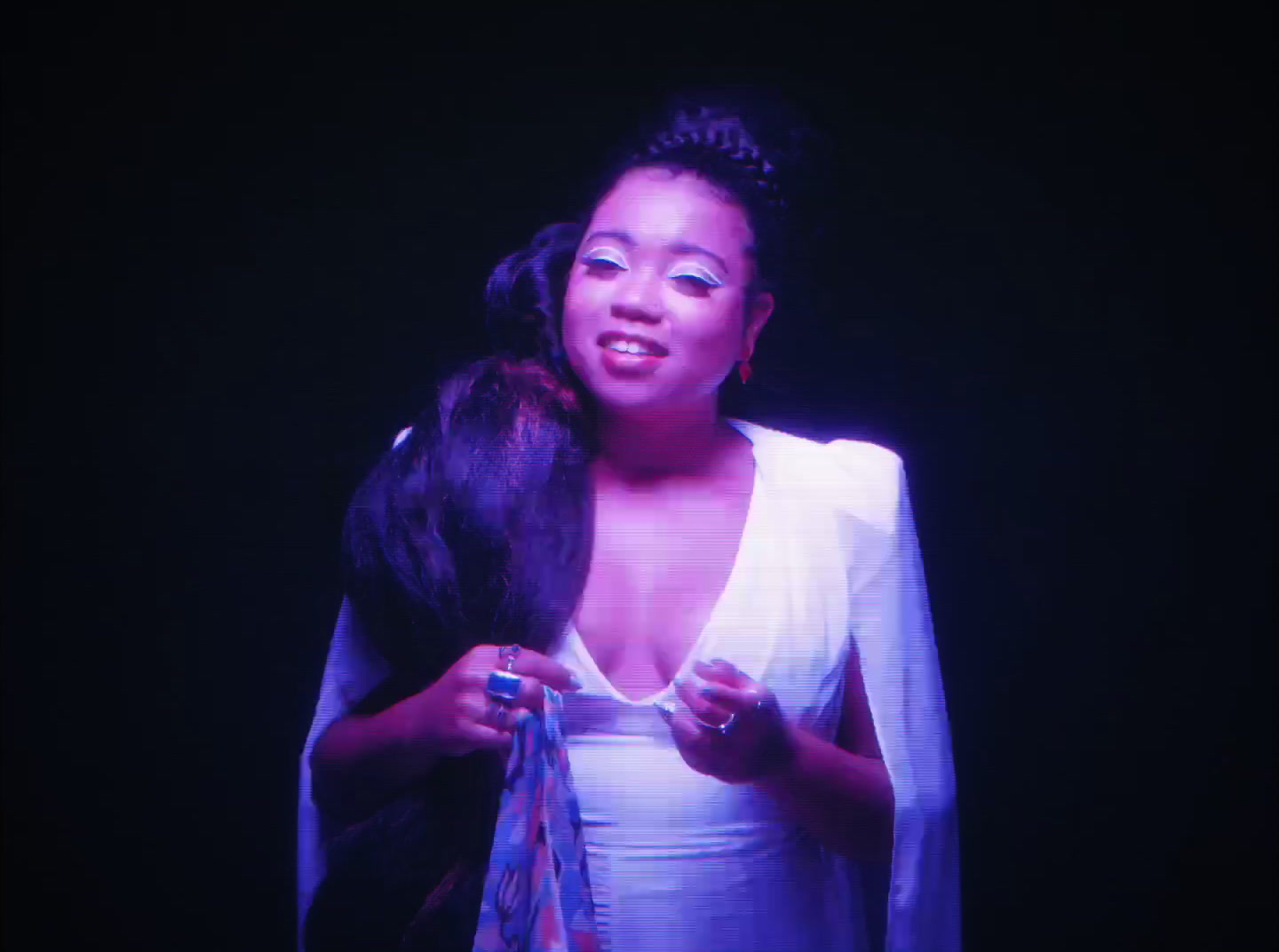 a woman in a white dress holding a black bird