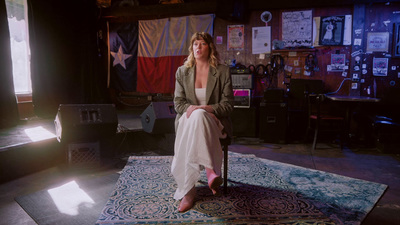 a woman sitting on a chair in a room