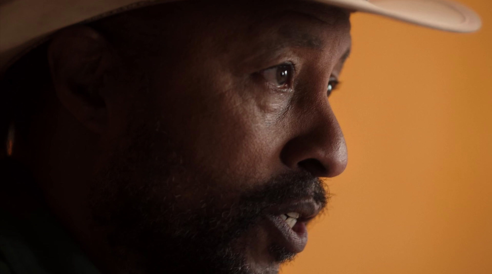 a close up of a person wearing a hat