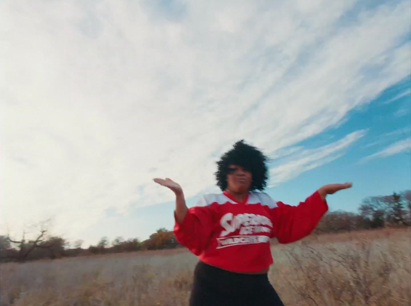 a person standing in a field with a frisbee