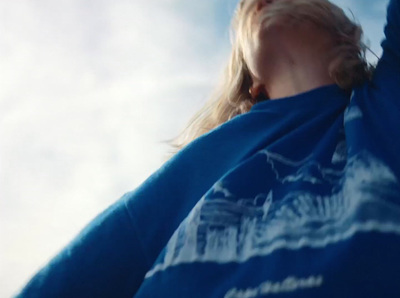 a woman holding a frisbee under a blue sky