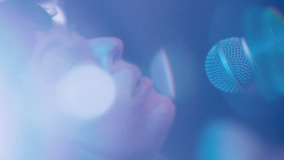 a close up of a person holding a microphone