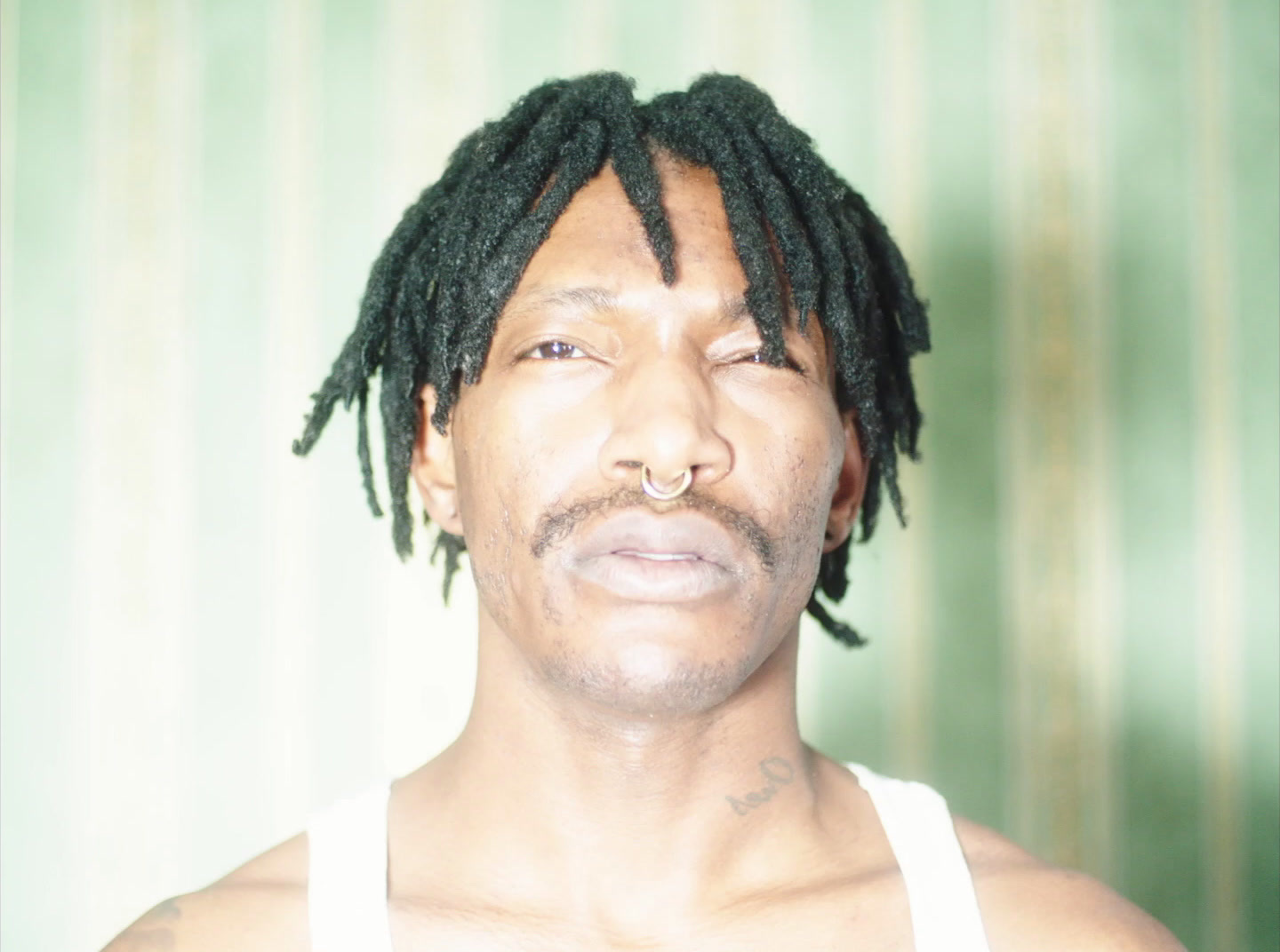 a close up of a person with dreadlocks