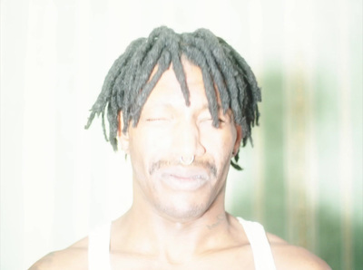 a close up of a person with dreadlocks