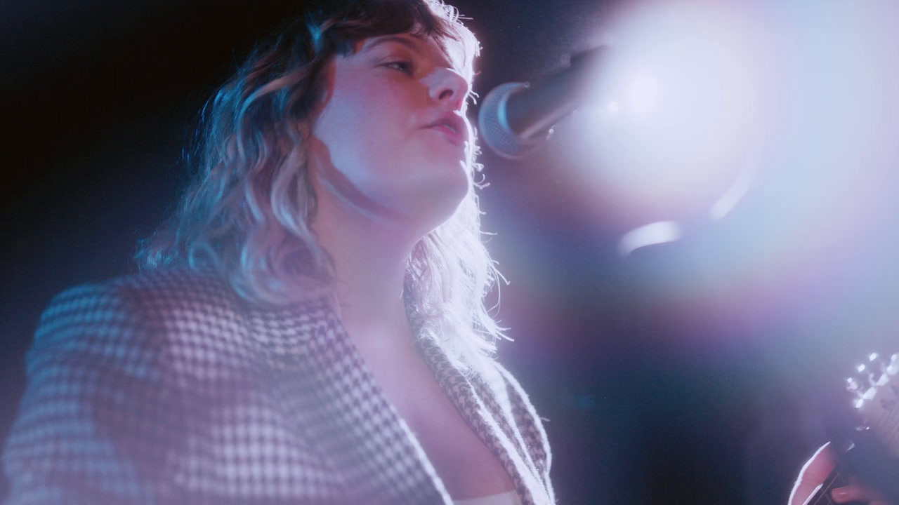 a woman standing in front of a microphone