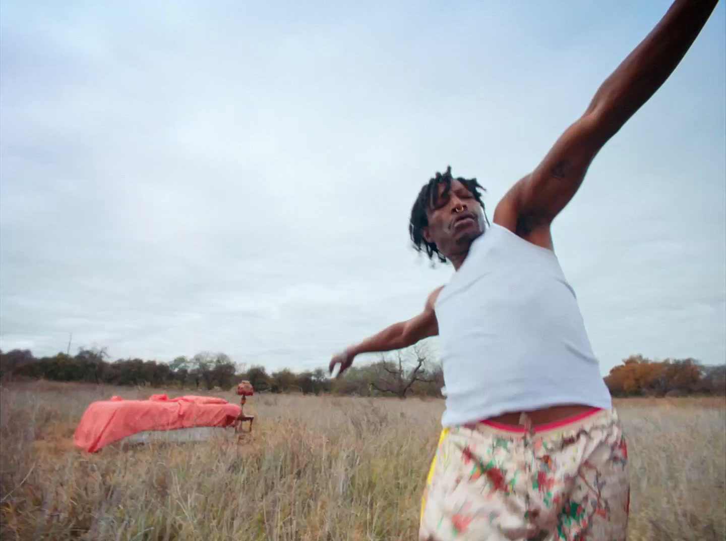 a man is throwing a frisbee in a field