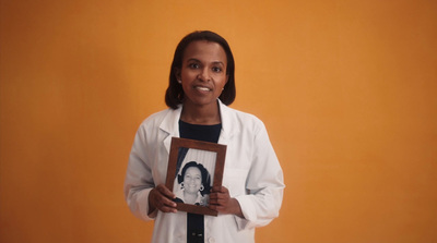 a woman holding a picture of herself in a frame