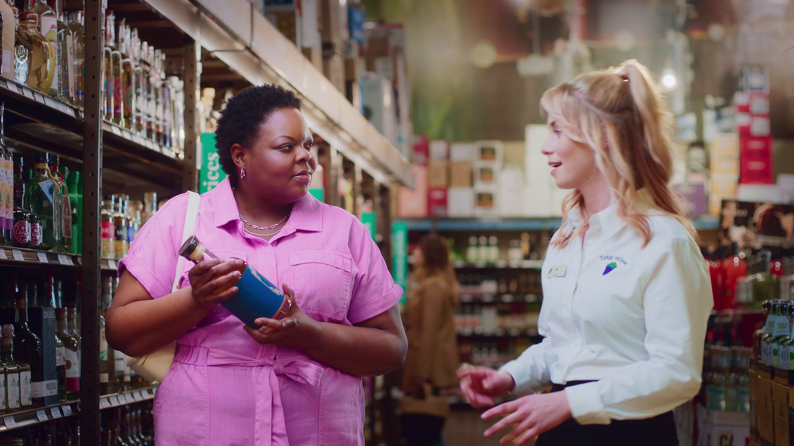 two women in a store talking to each other