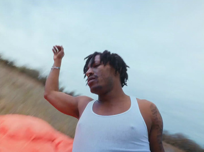 a man with dreadlocks holding a frisbee