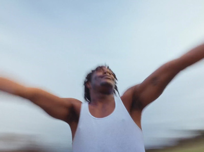 a man with his arms outstretched in the air