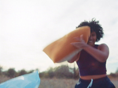 a woman holding a surfboard on a beach