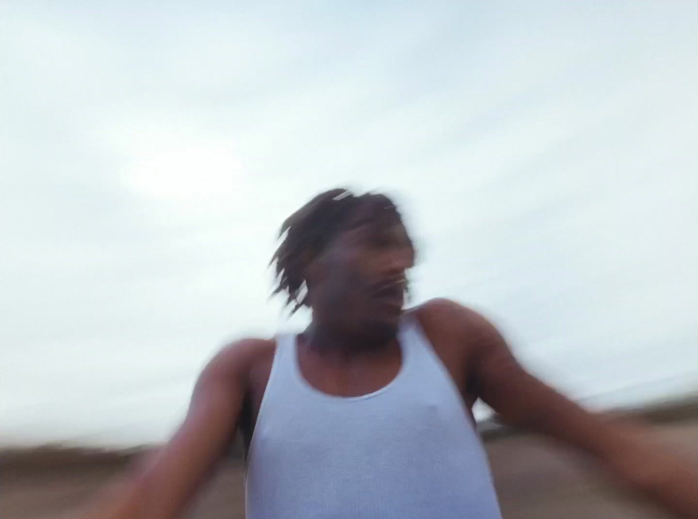 a blurry photo of a man in a tank top