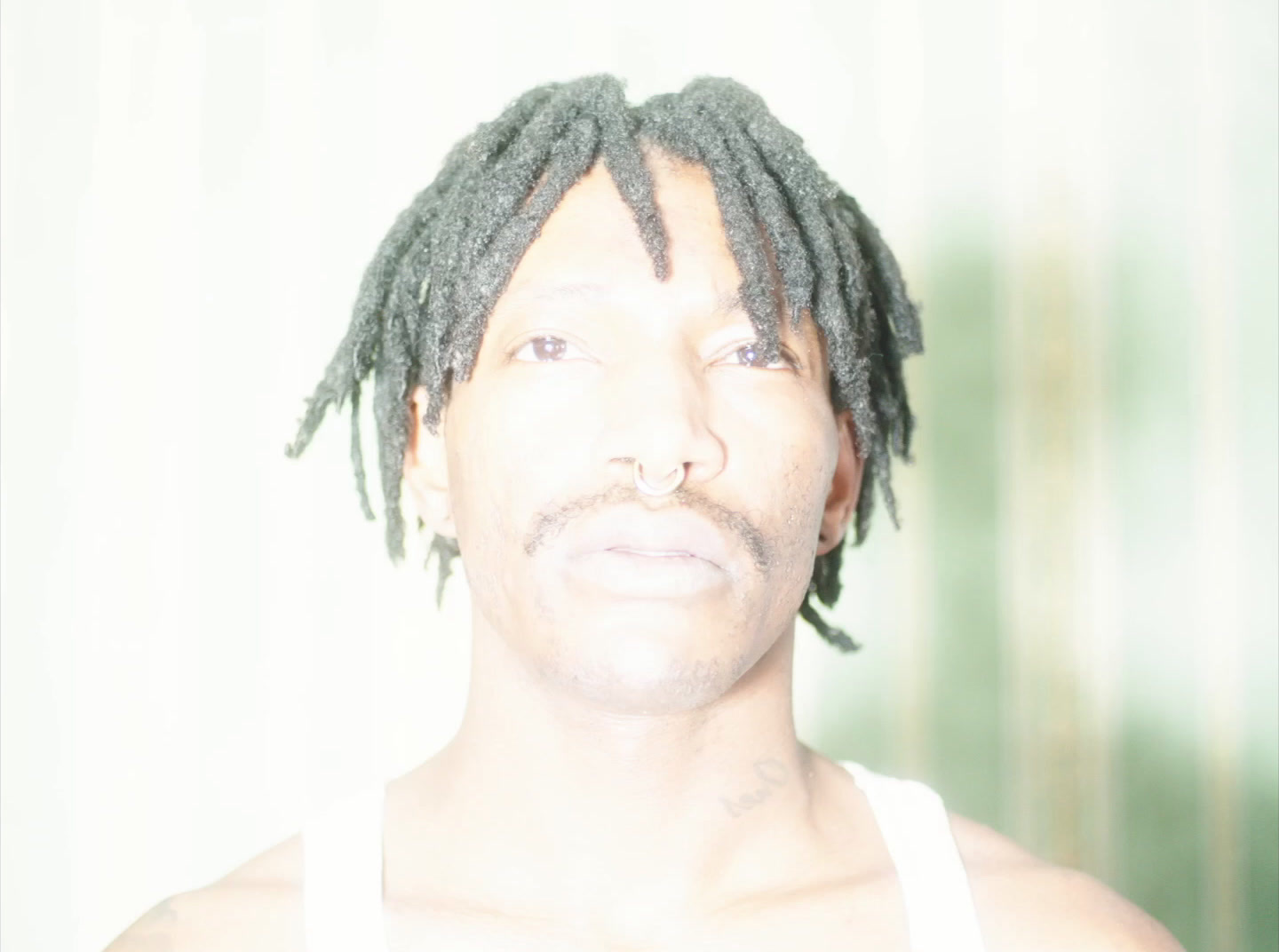 a close up of a person with dreadlocks