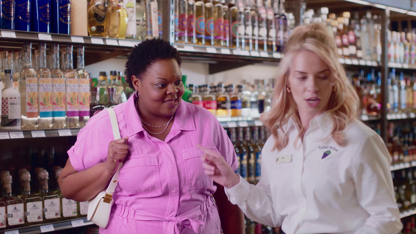 two women standing in front of a store shelf