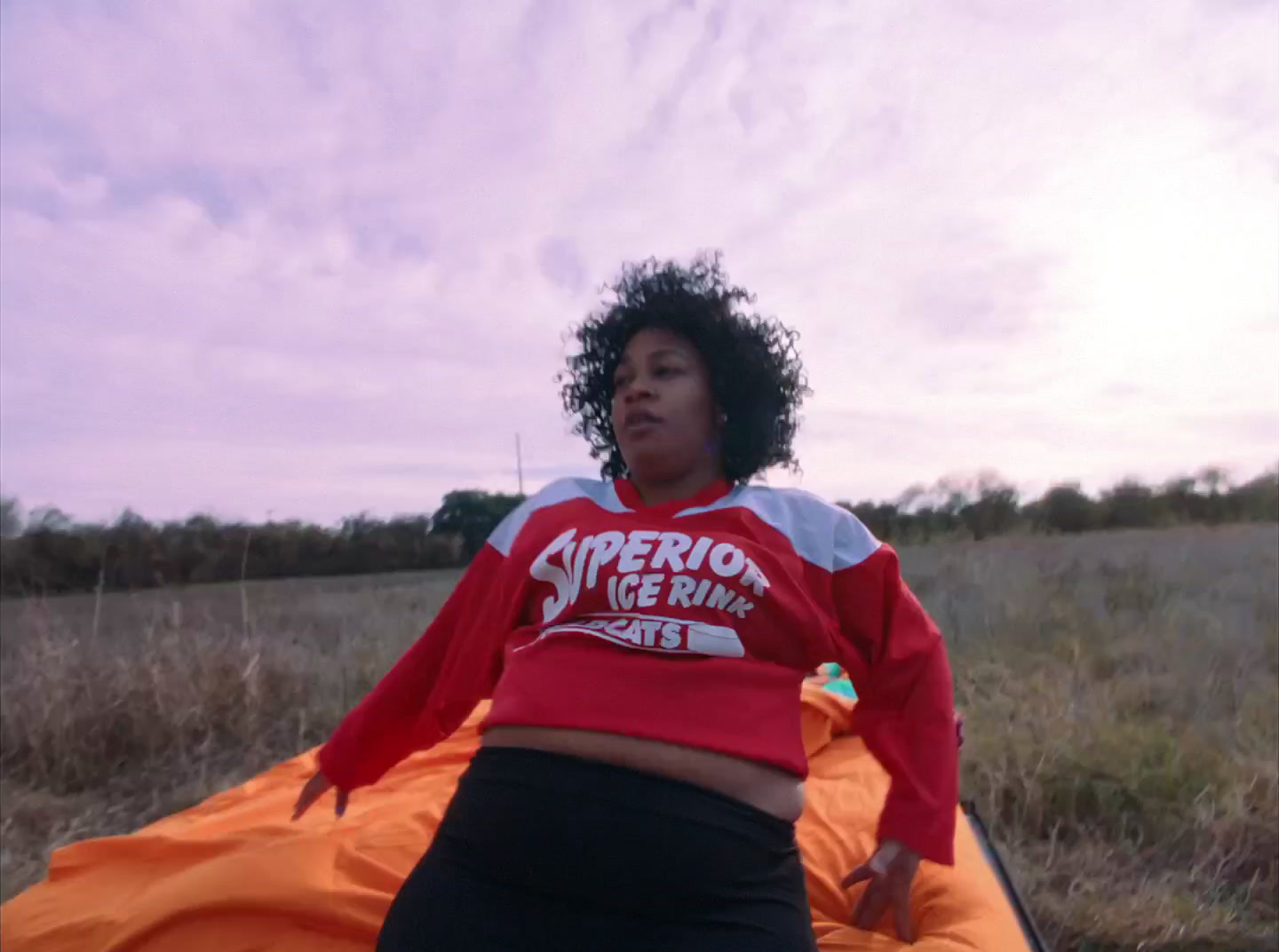 a woman in a red shirt and black pants