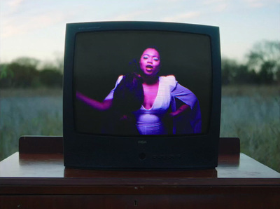 a television with a picture of a woman on the screen