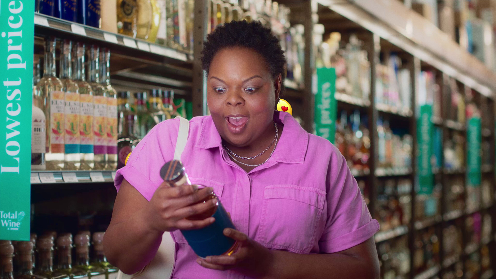 a woman looking at a can in a store