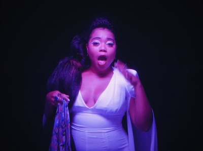 a woman in a white dress holding a purple scarf