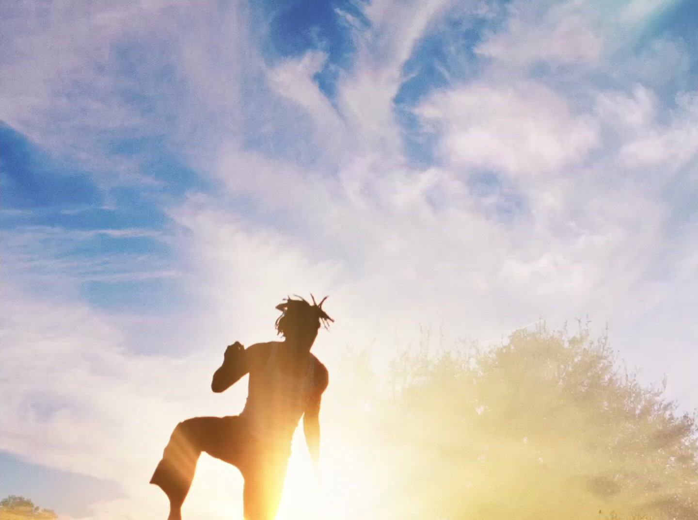 a person standing on a surfboard in the sun