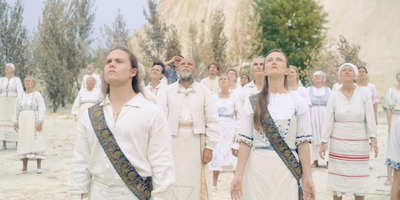 a group of people standing in front of a mountain