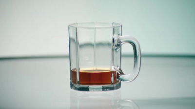 a glass mug with a liquid inside of it