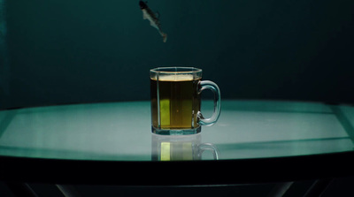 a glass of beer sitting on top of a table