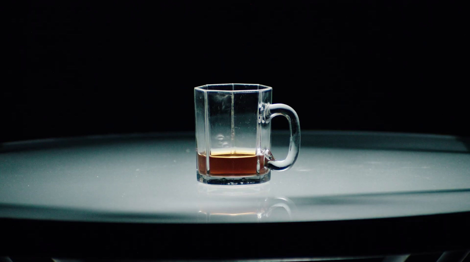 a glass of liquid sitting on top of a table