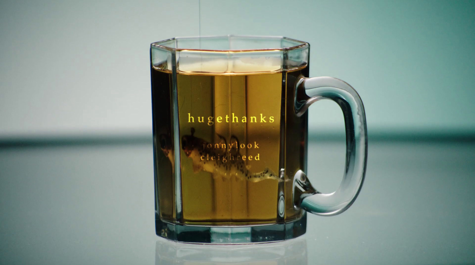 a glass mug filled with liquid on top of a table