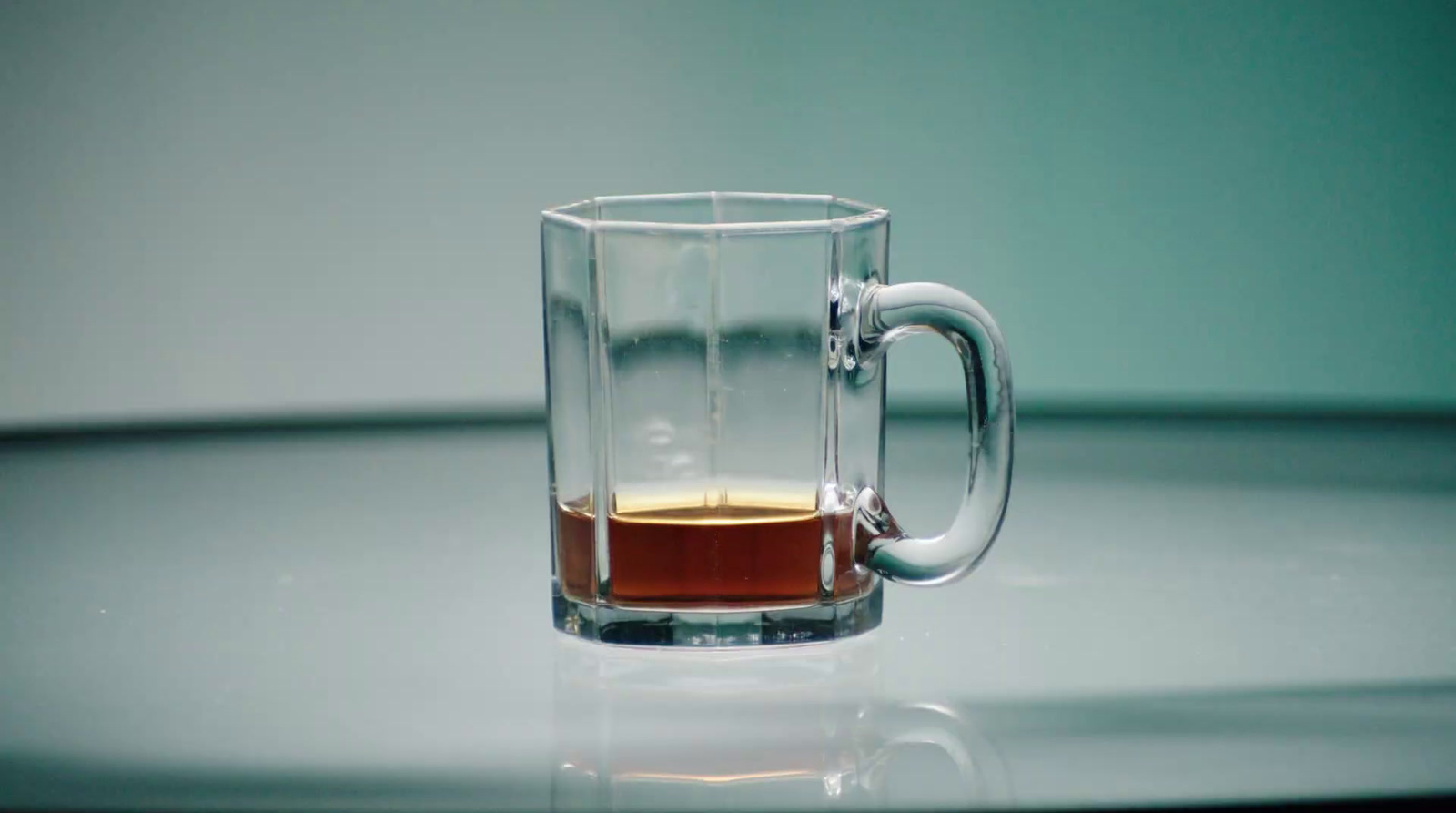 a glass mug with a liquid inside of it