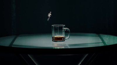 a glass of beer sitting on top of a table