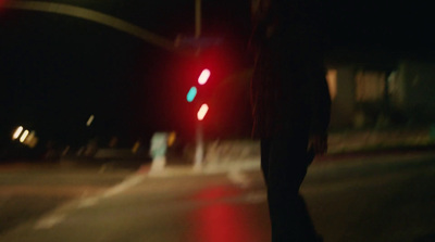 a blurry image of a person walking across a street at night