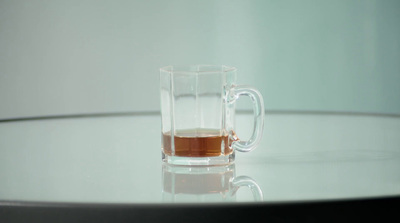 a glass of tea sits on a table