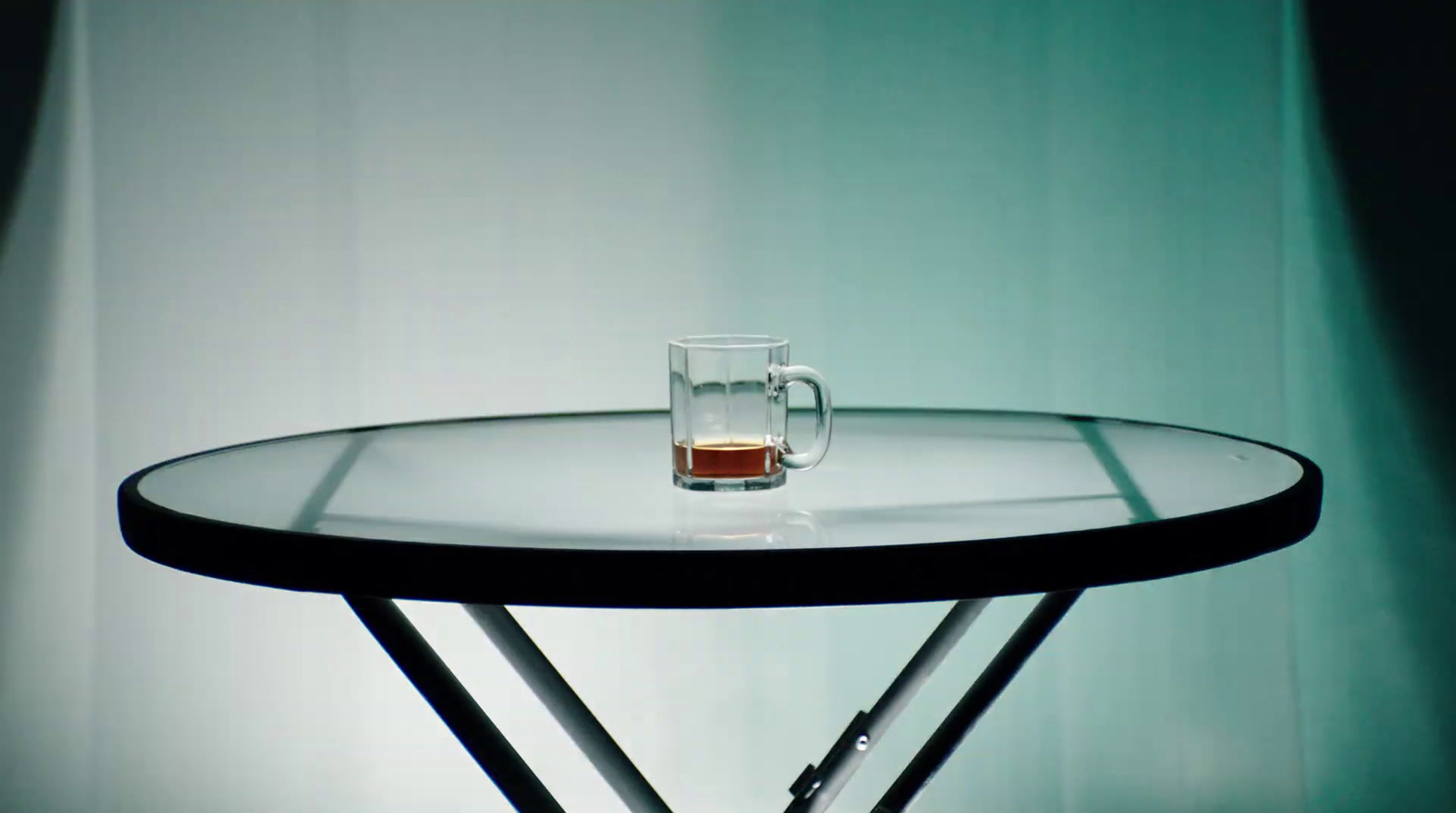 a glass of beer sitting on top of a table